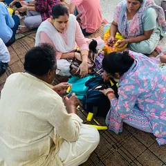I always sit with my students to help them directly. Here, I am showing a group of teachers the technique for making a simple hand puppet.