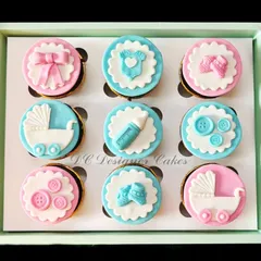 These delicate baby shower cupcakes are a popular choice for welcoming a new arrival. Each chocolate cupcake is topped with intricate, handmade fondant designs like baby carriages, booties, and bows in a classic pink and blue theme.