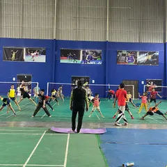 A certified instructor leads a group yoga session on the court. We focus on poses that improve flexibility in the hips, shoulders, and back, which are crucial for powerful and fluid movements in badminton.