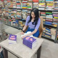 Signing books at a bookstore surrounded by stacks of books. This is the dream. I'm so grateful for every opportunity to connect with the reading community.