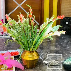 We use fresh, vibrant flowers to bring life to our setups. This close-up shows a traditional brass vase filled with beautiful gladiolus and tuberose, a simple yet elegant detail that adds fragrance and grace to the decor.