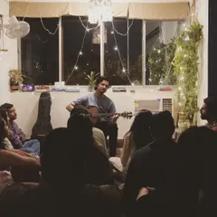 Performing my heart out for a beautiful audience at an intimate music gathering. There's something special about sharing songs and stories in such a close and personal setting.