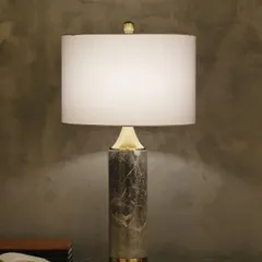 We celebrate timeless materials in our designs. This table lamp features a solid pillar of mid-century modern marble, bringing a sense of natural luxury and grounded sophistication to your side table or console.