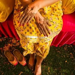 A top-down shot showing how minimal henna on the hands and feet can create a complete and elegant bridal look.