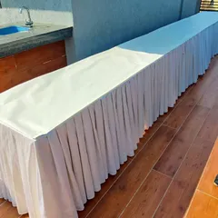 A clean and simple buffet table with a white skirt, which I provided for the rooftop party to serve food and drinks.