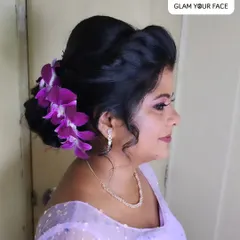 You can never go wrong with accessorizing your hair with real flowers. Here, I used beautiful purple orchids to adorn a messy bun, creating a timeless and elegant hairstyle that complements the monochromatic makeup.