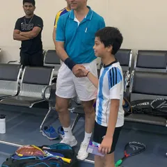 A moment of sportsmanship at the Willingdon Squash Academy tournament, as a young player receives his prize.