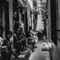 This is the kind of moment I live for. A bride moving through the real, beautiful chaos of her world on her wedding day. This black and white street-style bridal shot captures the authentic story.