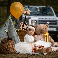 A first birthday celebration set against the beautiful backdrop of the Shimla hills. I arrange these outdoor milestone sessions to feel like a fun family picnic, complete with a custom setup including a tent, balloons, and a teddy bear.
