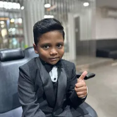 This dapper young man is looking sharp in his suit and tie after a fresh haircut and style. I gave him a classic side-parted look perfect for a special occasion.