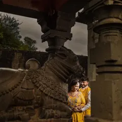 A quiet moment of connection within the hallowed walls of an ancient temple. The stone pillars and historic sculptures provide a timeless and soulful backdrop for this couple's portrait.