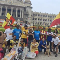 The team posing with collected trash bags and Karnataka flags in front of the Vidhana Soudha. This is our way of giving back to the community and keeping our running routes clean.
