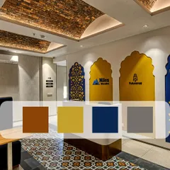 This entrance at Miles Education blends traditional motifs with a modern color palette. The design features custom archways with brand logos, intricate floor patterns, and a unique brick-tiled arched ceiling.