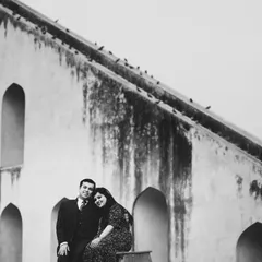 A classic black and white portrait at Jantar Mantar in Delhi. The historic monument adds a sense of timelessness to their story.