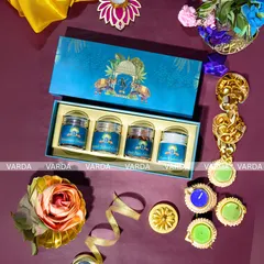 This royal blue gift box features a classic elephant motif, symbolizing good fortune and royalty. It contains four jars of gourmet dry fruits and nuts, making it an elegant and thoughtful wedding return gift.