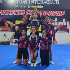 Our star gymnasts strike a powerful pose, showcasing the teamwork and artistry that defines our successful aerobic gymnastics program.