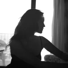 A black and white silhouette against a bright window. This artistic shot from my session with Vartika Singh plays with light and shadow to create a moody and evocative portrait without any edits.