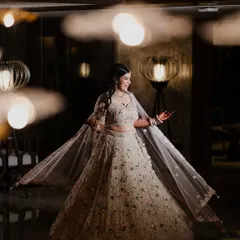 A beautiful full-length portrait of the bride twirling in her stunning Sangeet lehenga. The soft lighting and her joyful expression perfectly capture the elegance and happiness of the evening.