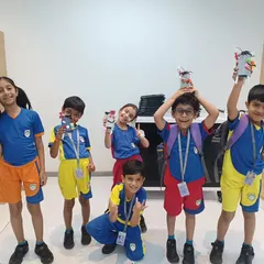 Success! A group of proud students shows off the unique robots they designed and built, each one a testament to their creativity and newfound STEM skills.