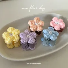 These are my mini flower clips, perfect for adding a pop of color. Each one is handmade and attached to a snap clip, available in pastel shades like yellow, lavender, peach, blue, and pink. They are great for pinning back bangs or decorating braids.