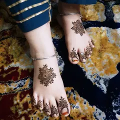 This angle shows the beautiful symmetry of the mandala designs on both feet.