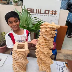 Look at that smile. This is the moment of pride and accomplishment that I strive to create in every workshop. After focusing, trying, and sometimes failing, seeing your own idea stand tall is an incredible confidence booster. This is how we build resilience, one block at a time.