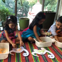 Birthday fun continues with more sensory play. The kids are now working with dough and creating turtle-themed crafts on their individual trays.