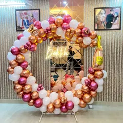 A beautiful circular balloon frame in white, pink, and rose gold, with a 'Bride to be' neon sign, creating a perfect photo booth for a bridal shower.