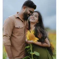 A candid moment of laughter in a field of sunflowers. Our pre-wedding photography focuses on capturing your genuine connection and happiness.