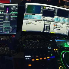 This is my command center. I'm not just playing tracks; I'm performing as a DJ and a VJ simultaneously. Using Pioneer DJ gear for the sound and Resolume with Madrix for the visuals, I create a complete sensory experience from the console.