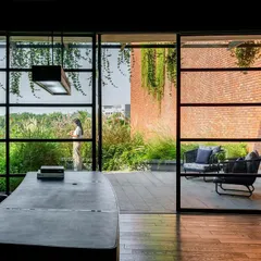 I love to blur the line between indoors and outdoors. This office at the Greenlab factory features floor to ceiling windows that open onto a private terrace, making the surrounding landscape an integral part of the workspace.
