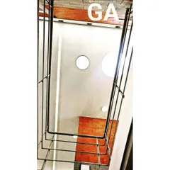 We find beauty in structure and form. This view looks up through the core of a building, showcasing the industrial design elements and the circular skylights that draw natural light deep into the office space.