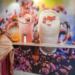 To reinforce the cafe's brand, we created a custom wall graphic featuring their signature rose milk drinks. This not only adds a pop of color but also serves as a great marketing element within the space.
