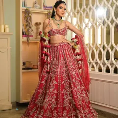 This vibrant red lehenga deserved a powerful pose. The dupatta is styled to showcase the detailed blouse and skirt, creating a look of pure confidence for this beautiful bride.