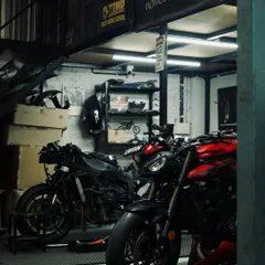The garage is buzzing with activity as we get bikes ready for the TWO track day. Here's a stripped-down bike next to a Triumph Street Triple.