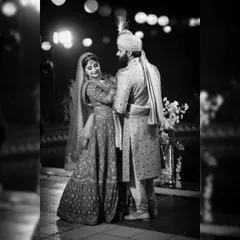 A classic black and white portrait of the couple on their wedding day. The beautiful bokeh from the lights in the background adds a touch of magic to this timeless shot.