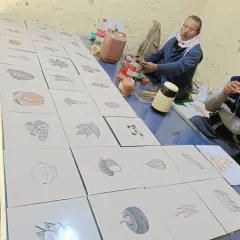 Me in my workshop, with a large series of botanical illustrations laid out on the table. This was part of a large commission for a client.