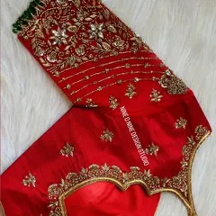 A masterpiece for our bride Madhuri. This classic red bridal blouse is heavily embroidered with zardosi and stone work, featuring a beautiful heart-shaped cutout on the back. The sleeves are a canvas of intricate floral patterns, making it a truly royal piece.