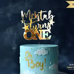 A first birthday is a huge milestone! This "Mehtab turns ONE" topper in a glossy gold finish looks fantastic on this "Oh Boy!" themed cake, showing how a custom piece can tie your whole party theme together.