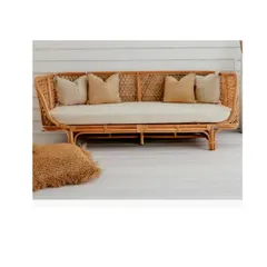 Designed for ultimate relaxation, this deep-seated rattan daybed offers a spacious and comfortable retreat. Its sturdy, handwoven frame and plush cushions make it a perfect addition to a covered patio, sunroom, or a cozy corner in a large living area.