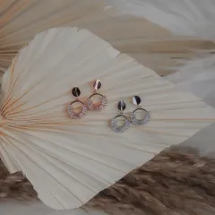 Styled shot of elegant hoop earrings for an e-commerce store. I used dried palm leaves as a prop to create a natural, bohemian vibe that complements the jewelry's design.