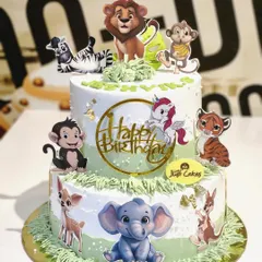 This 4kg two-tiered jungle animal cake uses a mix of edible prints and a unicorn topper for a whimsical safari party.