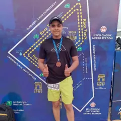 Proudly wearing my medal in front of the race track map. Every race is a new challenge and a new opportunity to prove your hard work.