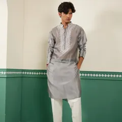 We believe in the quiet luxury of fine fabrics and detailed craftsmanship. This pearl grey kurta is crafted from lustrous Chanderi silk and features intricate Resham and silk thread embroidery on the placket and sleeves, offering a sophisticated look for any celebration.