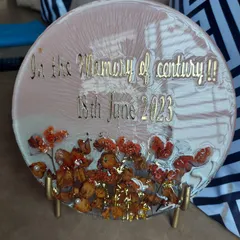 This memorial plaque was created to honor a loved one. The client wanted something simple and elegant to remember a special person. I used preserved flowers to create a beautiful tribute with the message "In the Memory of century".