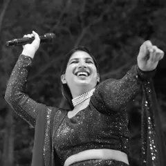 A joyful, black and white candid shot from a sangeet night. This image perfectly captures the pure happiness and high energy of the celebration.