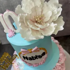 A close-up view of the handcrafted sugar flower, showing the delicate, paper-thin petals and detailed center. I spend hours on details like this to make your cake truly special.