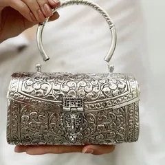 I believe accessories should be timeless works of art. This intricately carved German silver clutch is a statement of pure elegance, perfect for weddings and festive evenings. It is handcrafted to be an heirloom piece you will treasure forever.