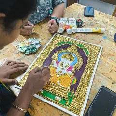 Another student works on a Tanjore painting of Lord Ganesha. I guide them through every step, from preparing the board to the final coloring, making this intricate art form accessible to all.