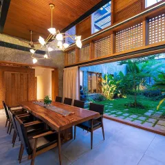 We believe in blurring the lines between indoors and outdoors. This dining area opens completely to a central courtyard garden, creating a seamless flow and allowing the homeowners to enjoy the greenery and natural light from within their home.